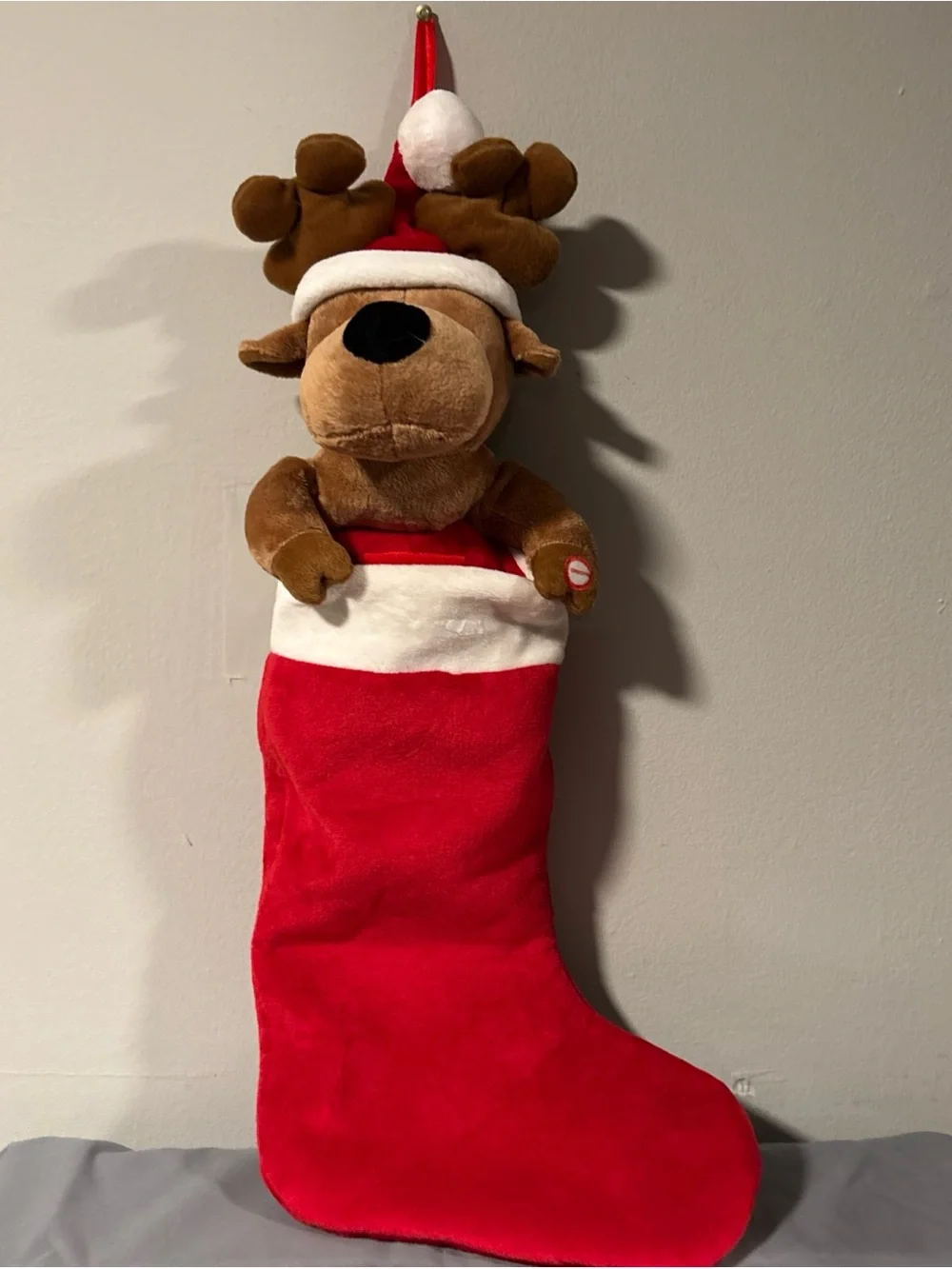 Holiday singing stocking with puppy dog sings jingle bells